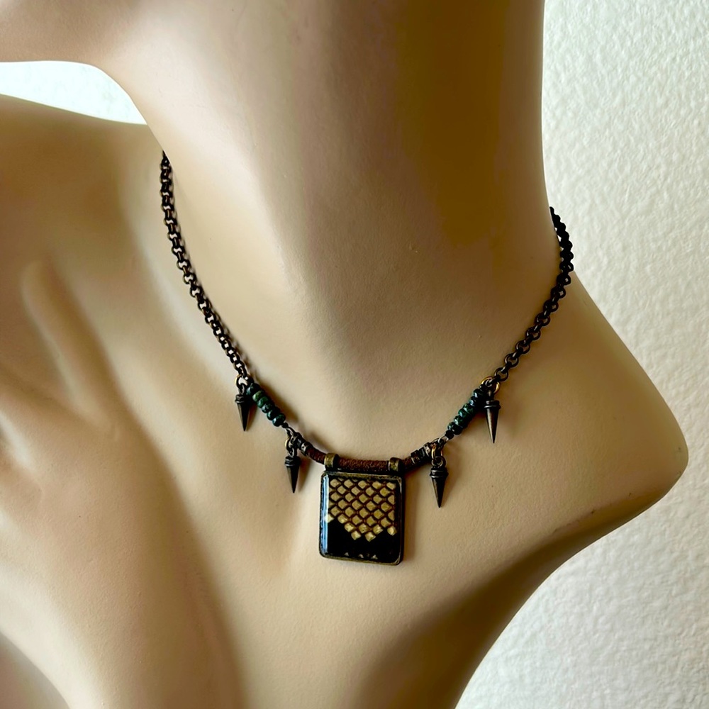 Shari Dixon coppery colored necklace.